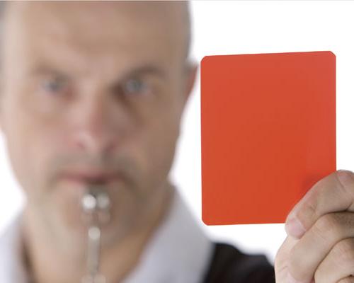 Referee holding a red card