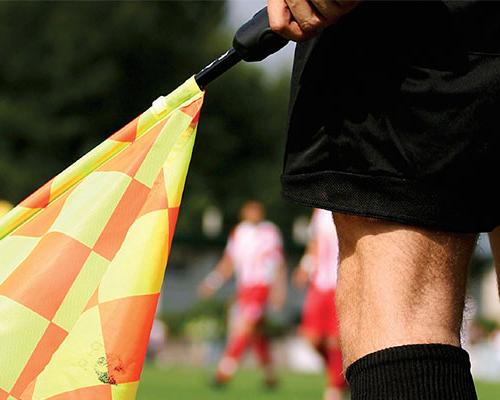 Referee holding a flag.